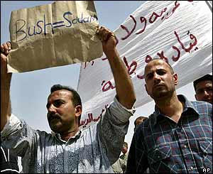 Man holds sign saying 